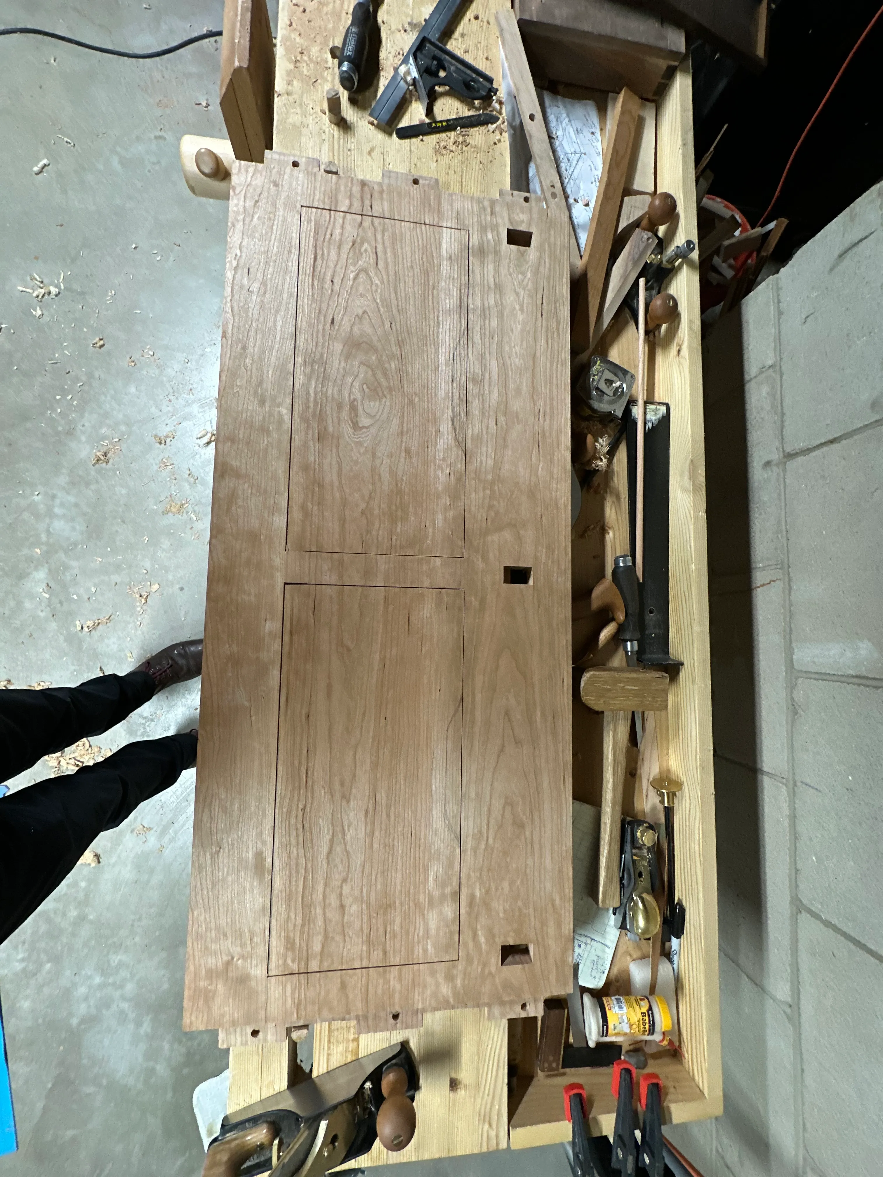 Case side panel on workbench showing mortises and drawbore holes