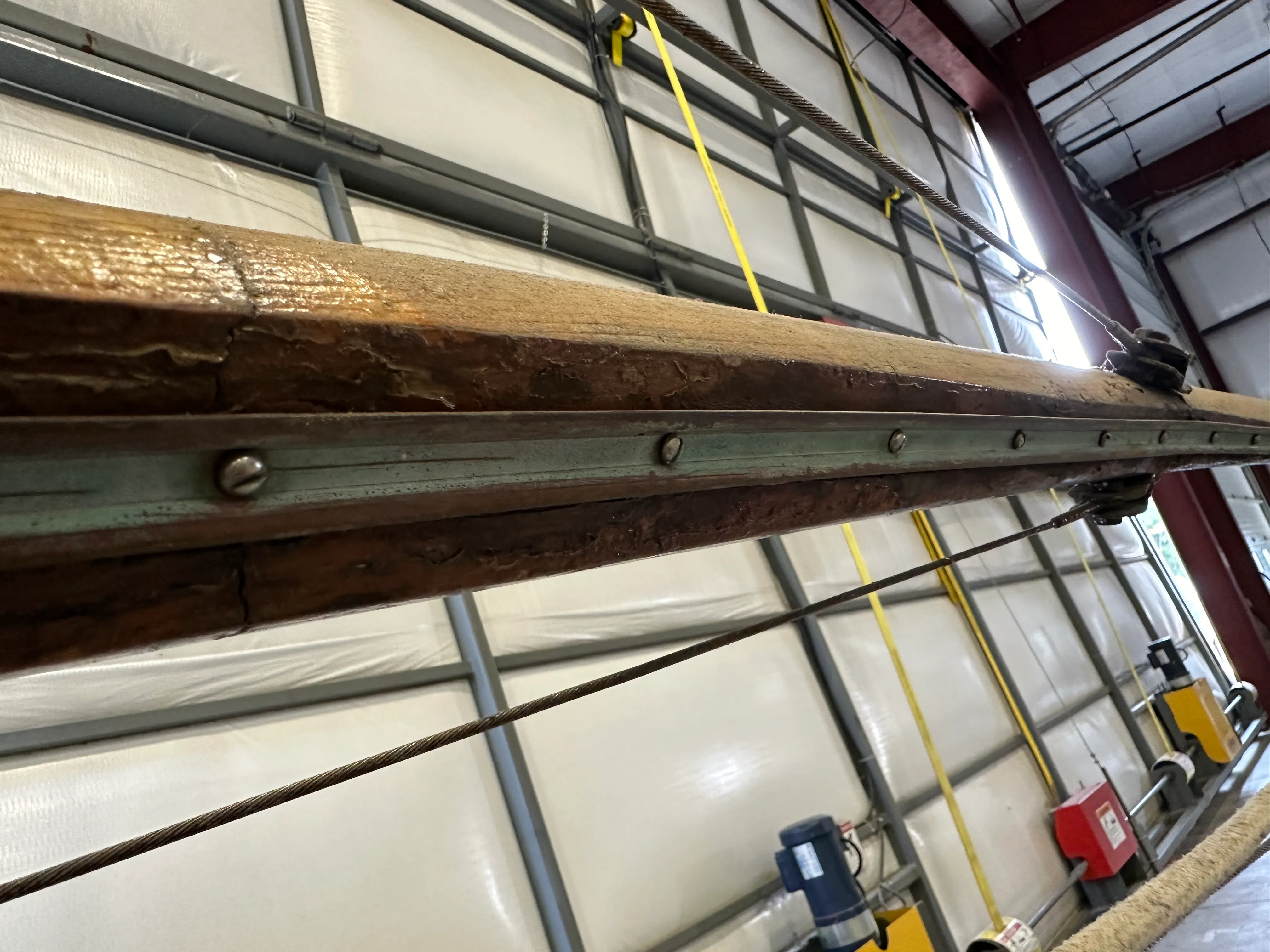 Old mast showing sail track and severe splitting