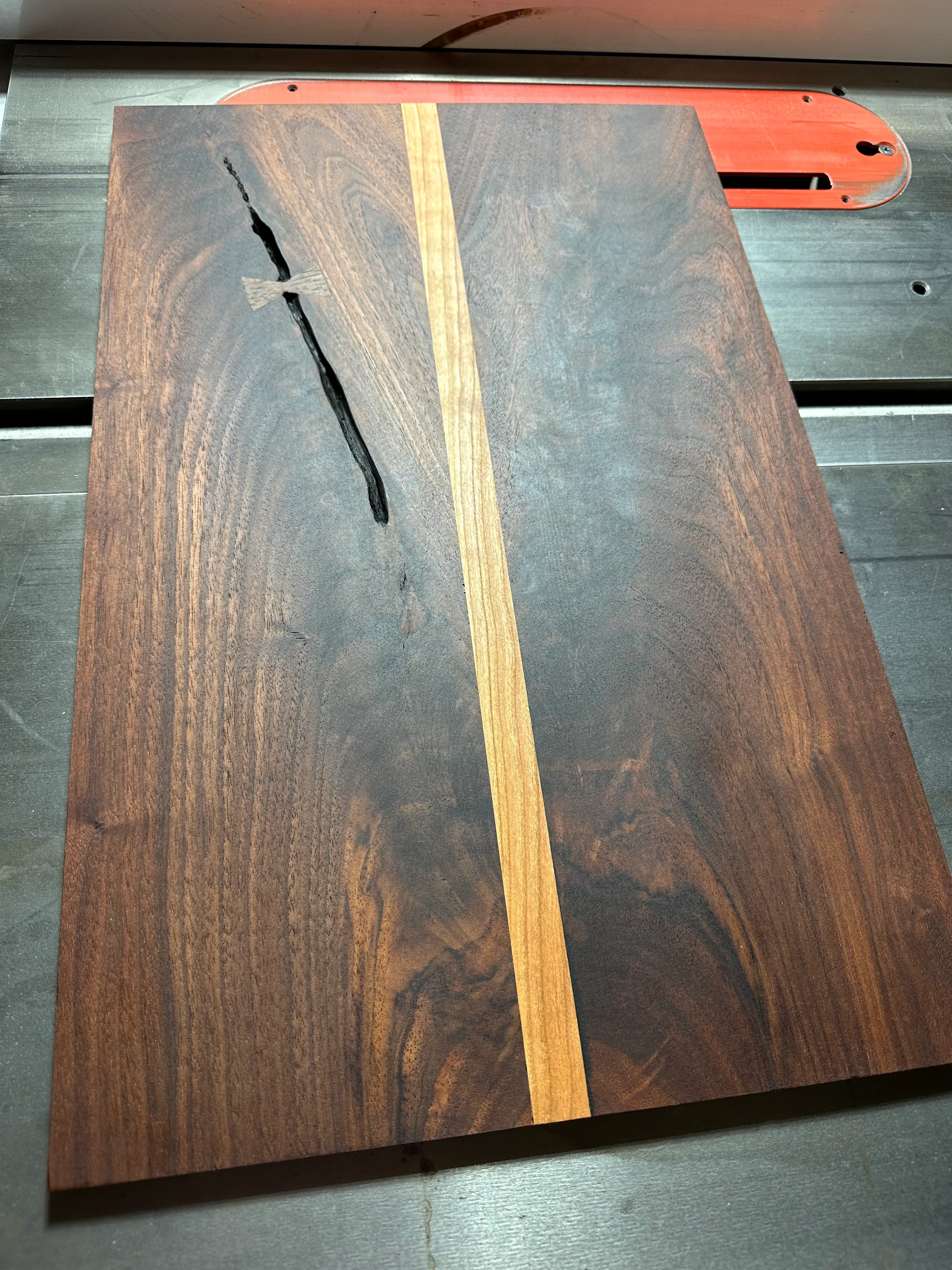 Book-matched black walnut crotch panel with maple center strip on the table saw