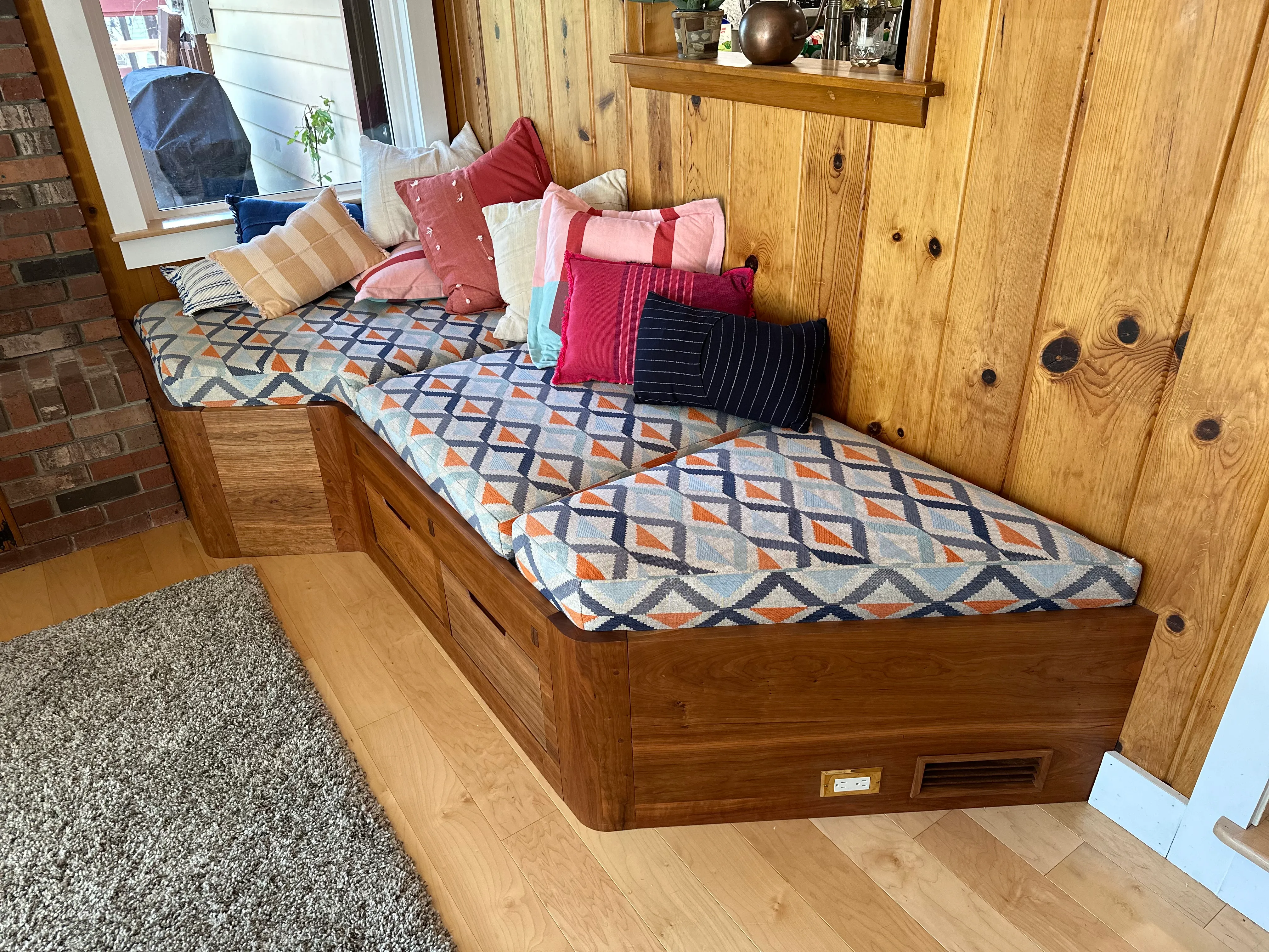 Finished cherry bench with cushions and pillows