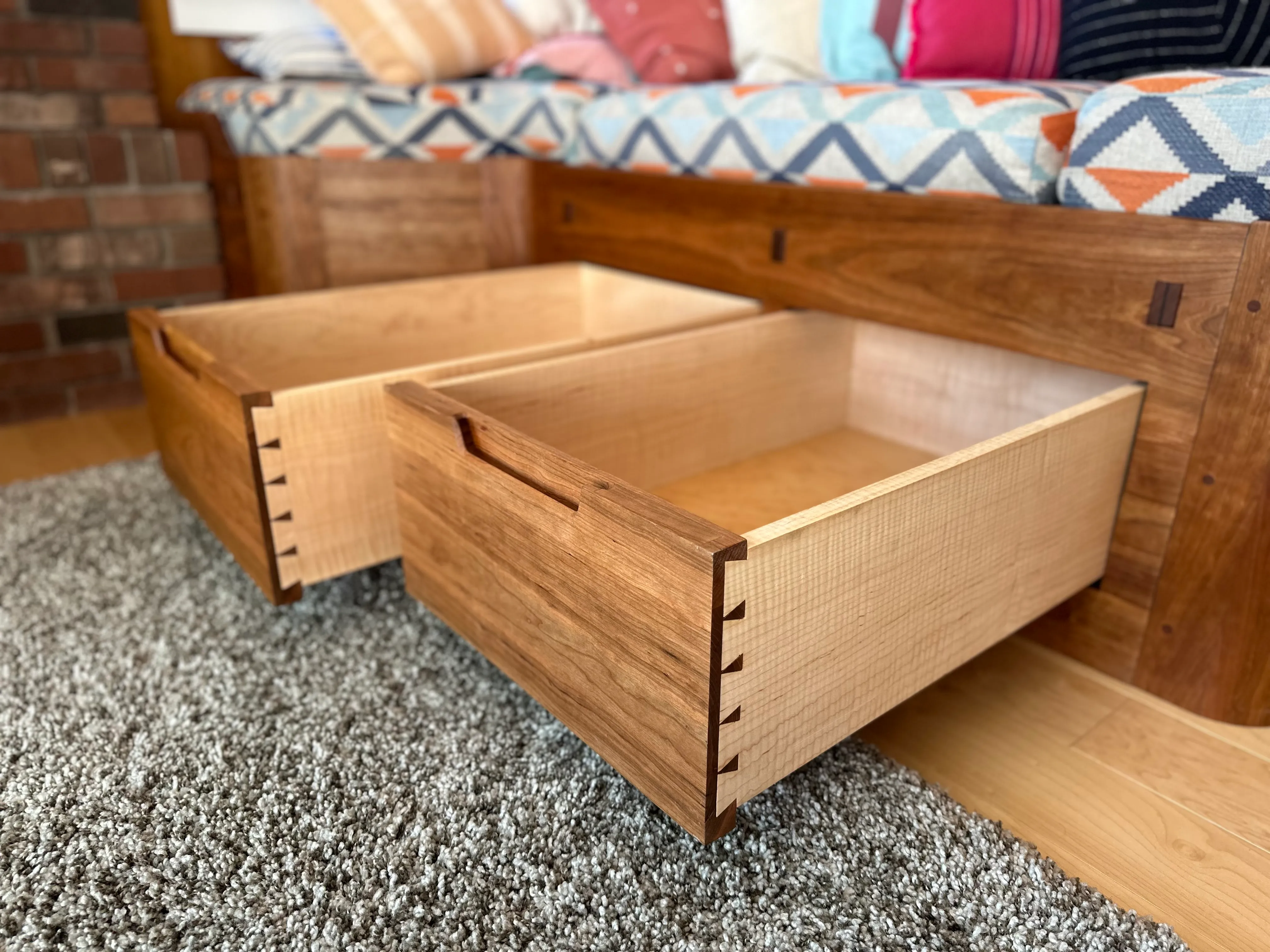Drawers pulled open showing half-blind dovetails and maple interior