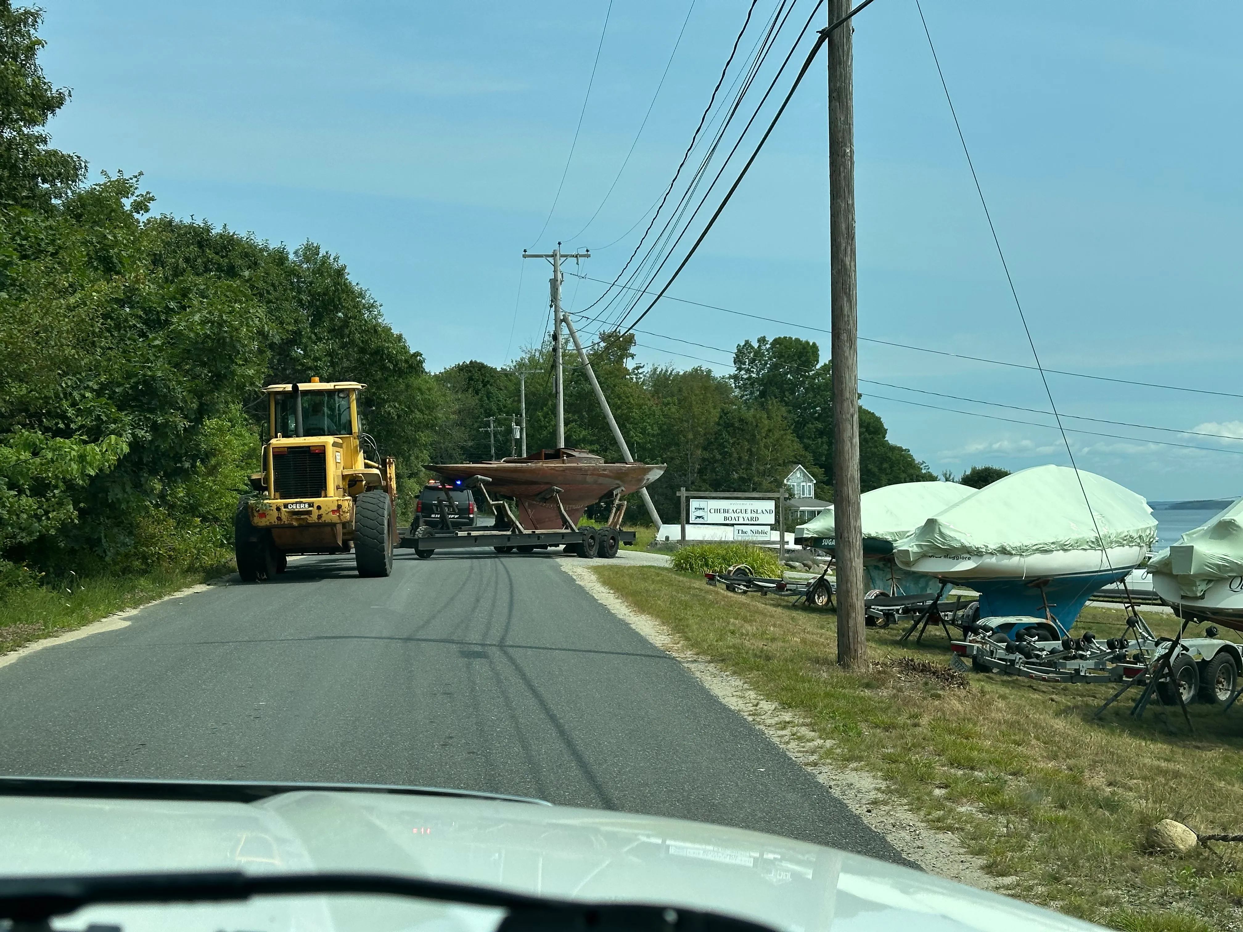 The boat on its trailer arriving at Chebeague Island Boat Yard, with the boatyard sign visible