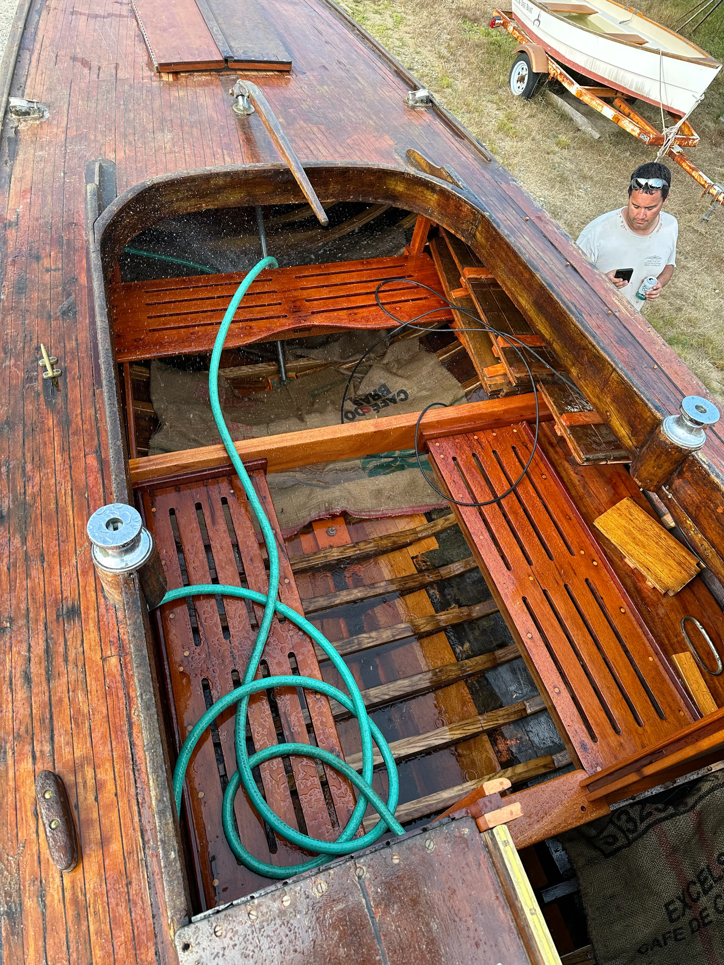 View from above looking down into the cockpit with a green hose running water into the interior