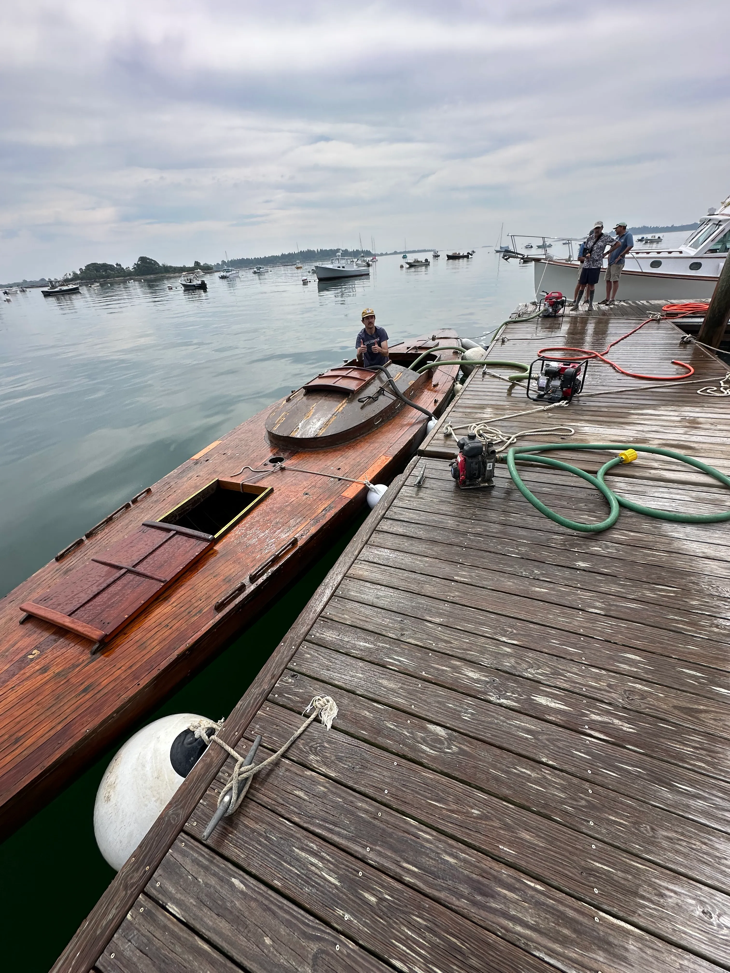 Boat alongside dock with pump equipment