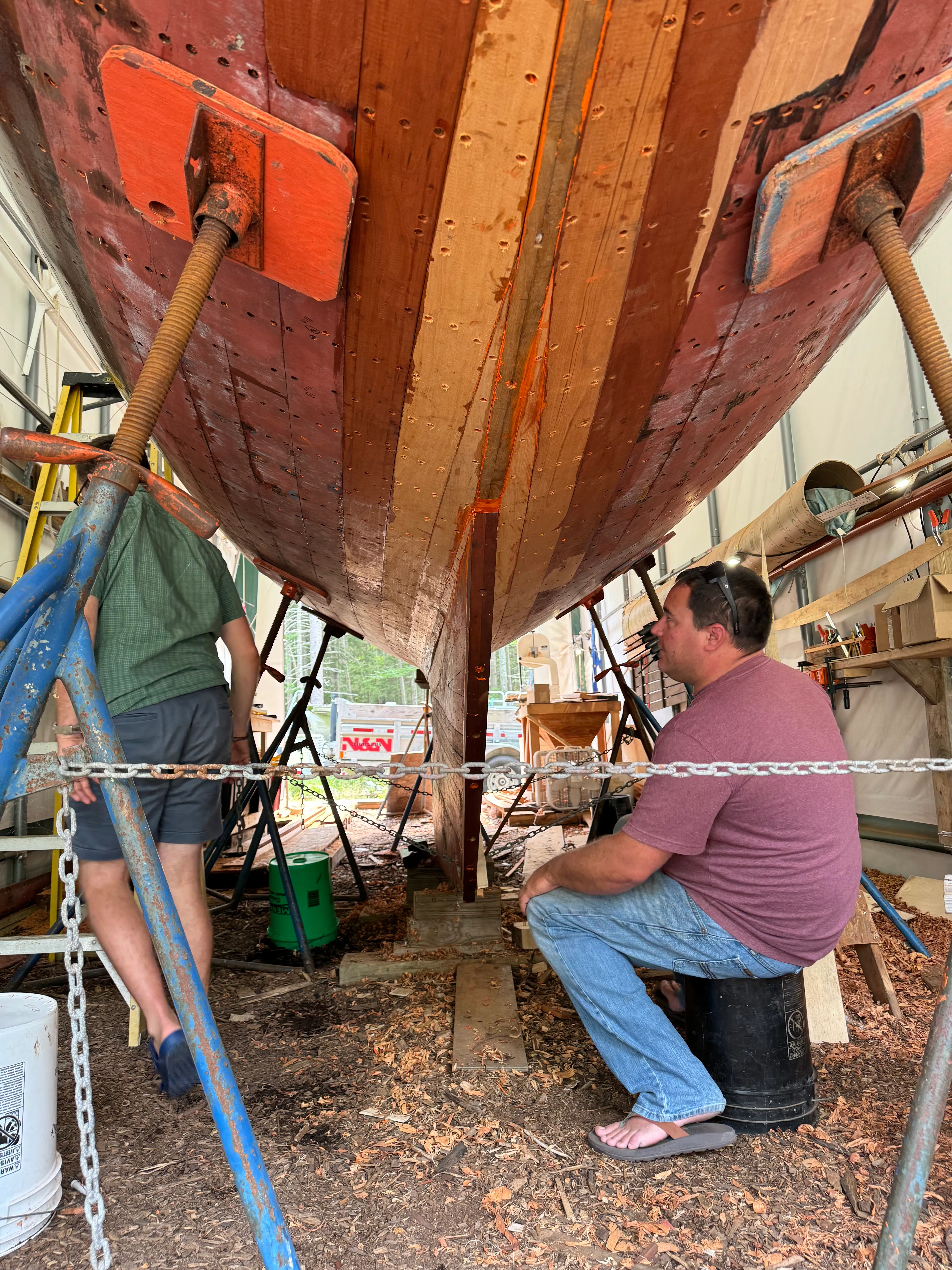 Two people working together on the stern planking