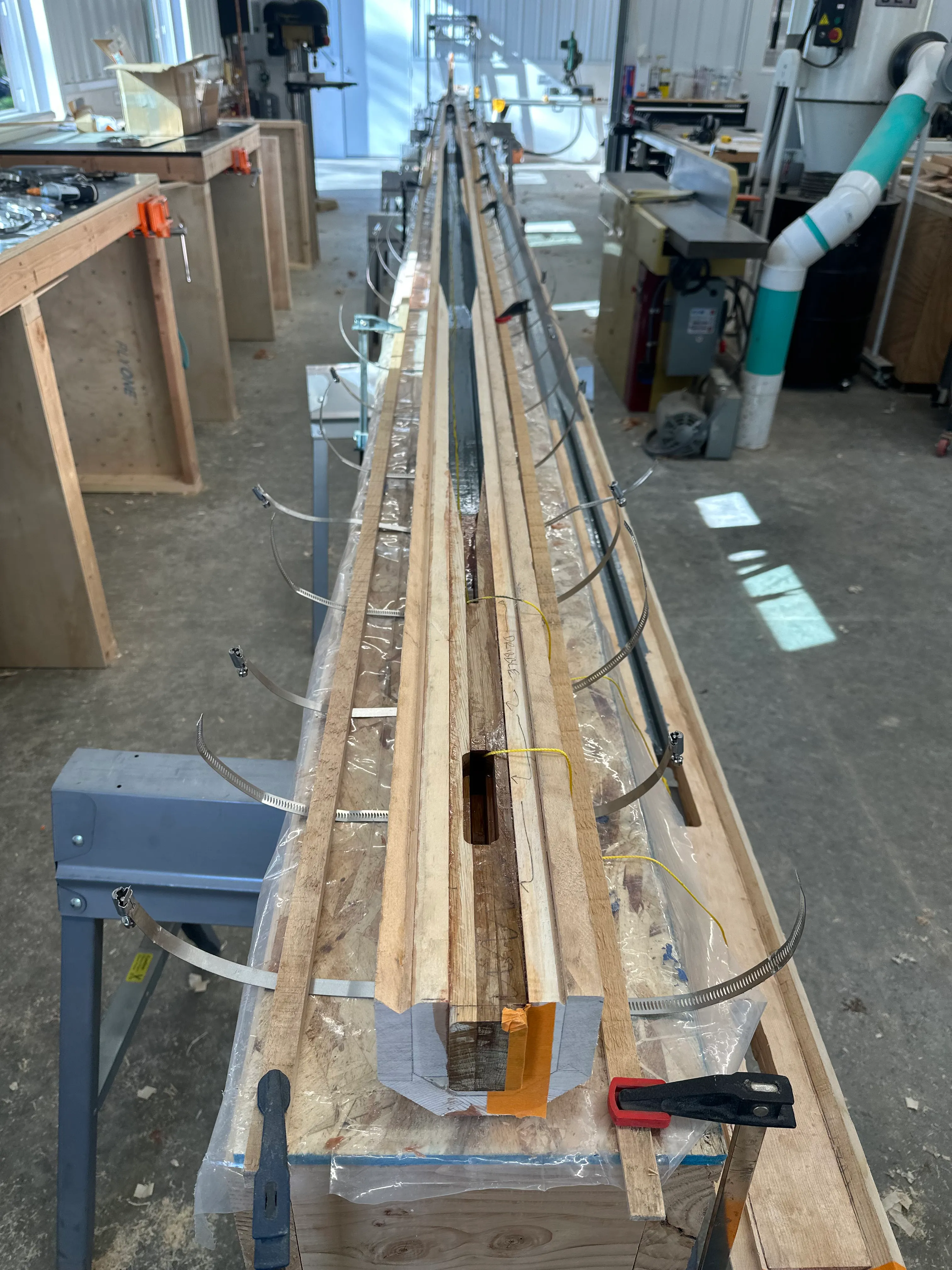 Mast prepared for final glue-up with blocking and halyard chase lines
