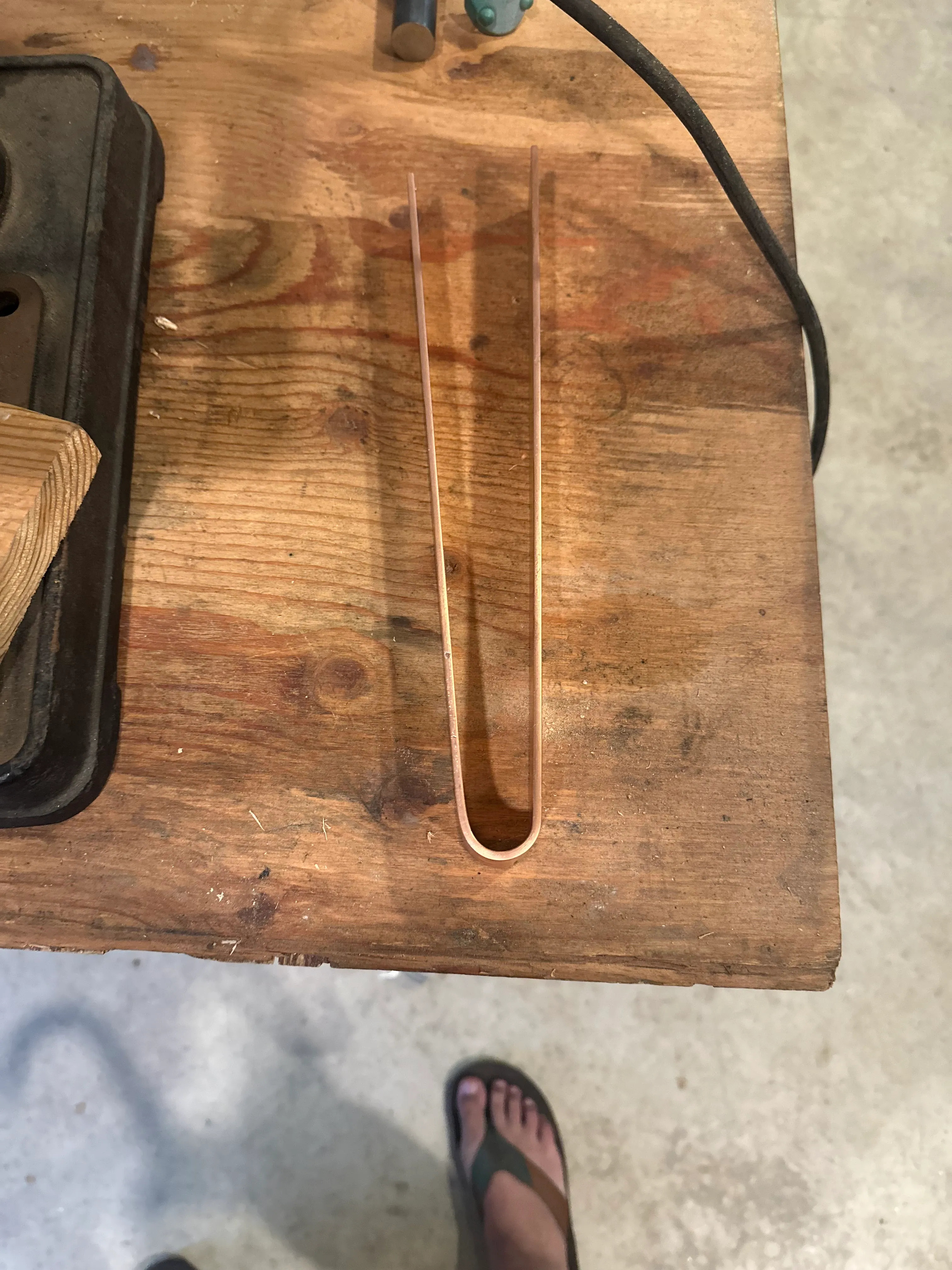 Copper rod bent into a U-shape on the workbench