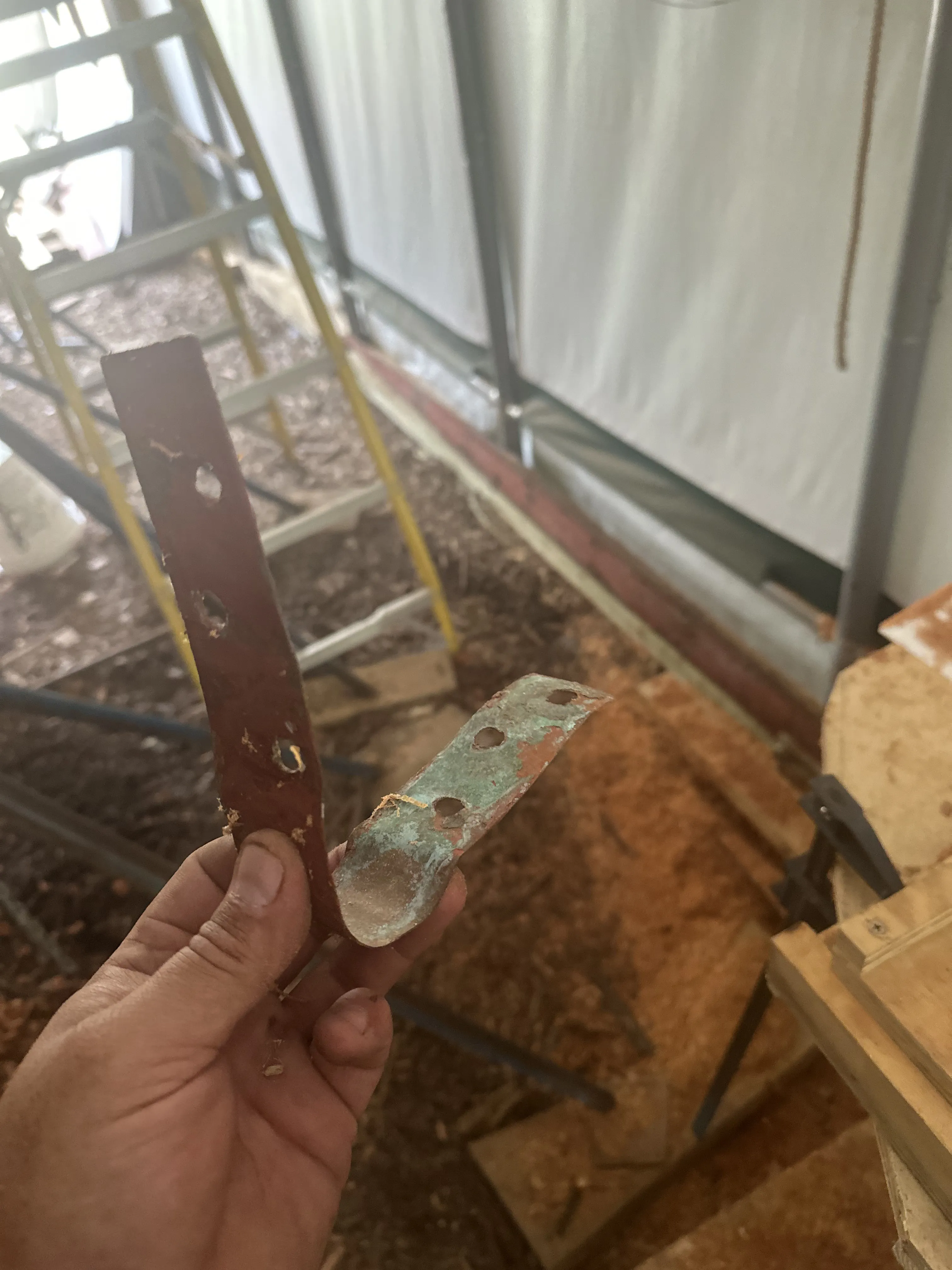 The original rudder post strap, a thin piece of metal resembling plumber's tape