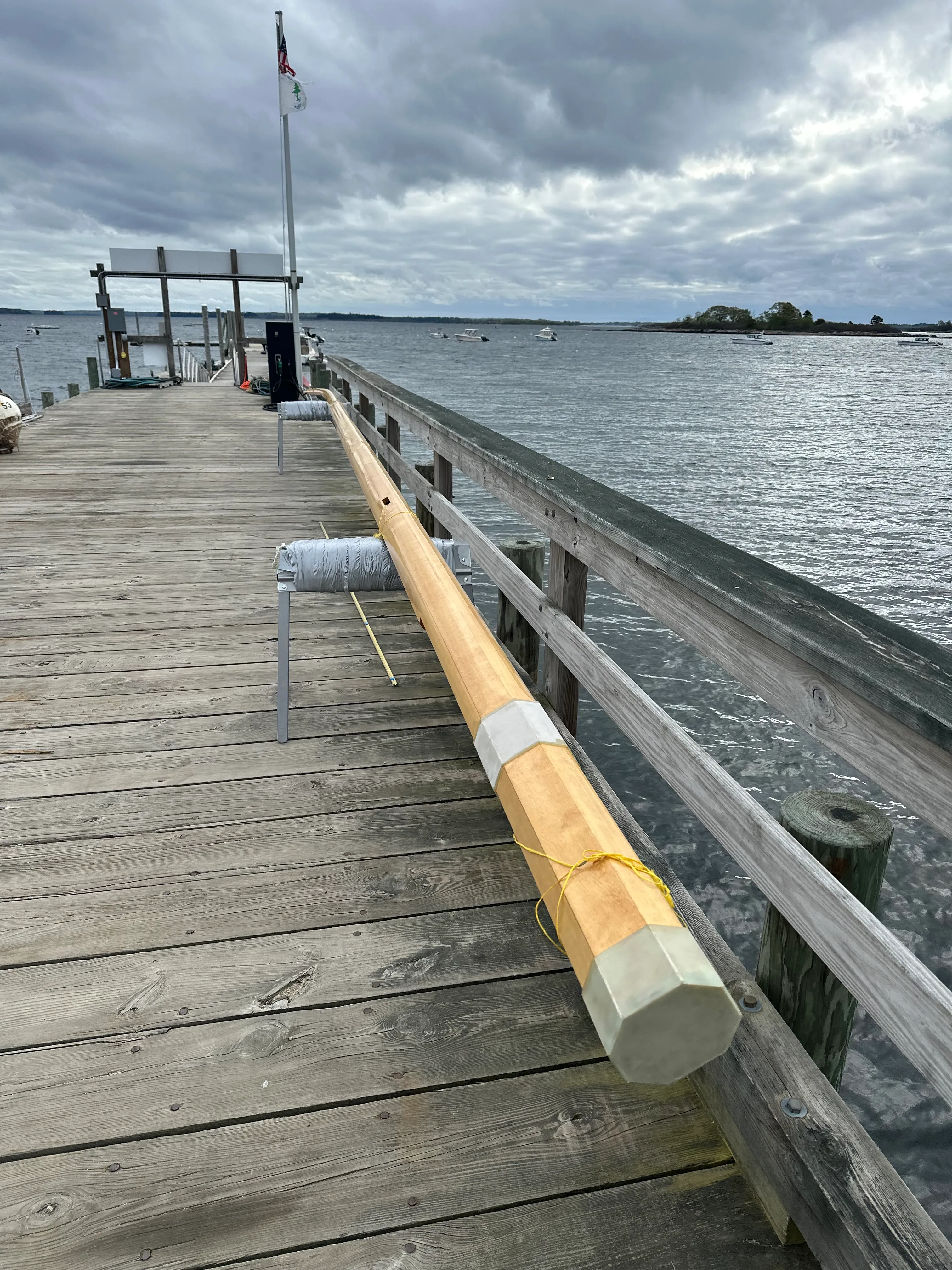 Finished spruce mast lying on a dock