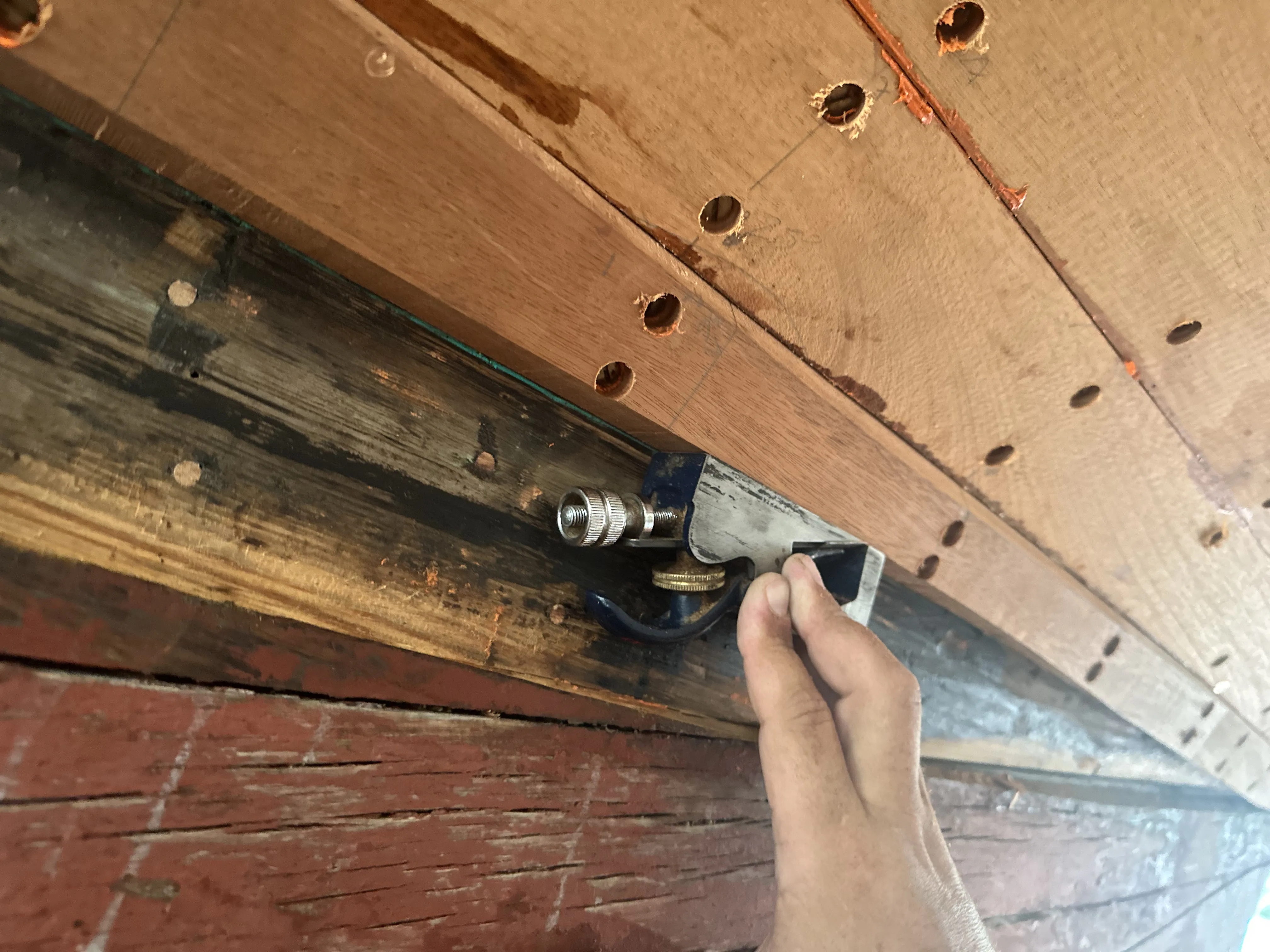 Squaring up a plank seam with a rabbet plane on the hull